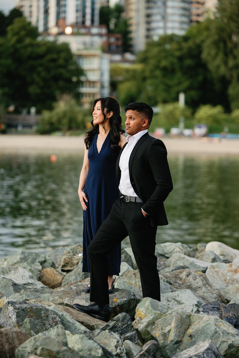 Eunice in a navy gown on the seawall, the Vancouver skyline across the water