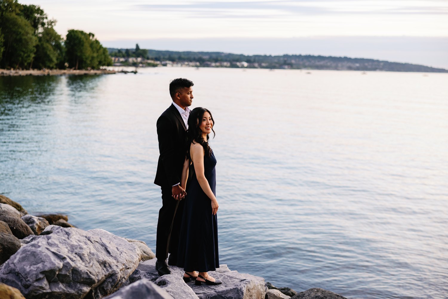 Eunice and Ashan on the rocks at sunset over English Bay