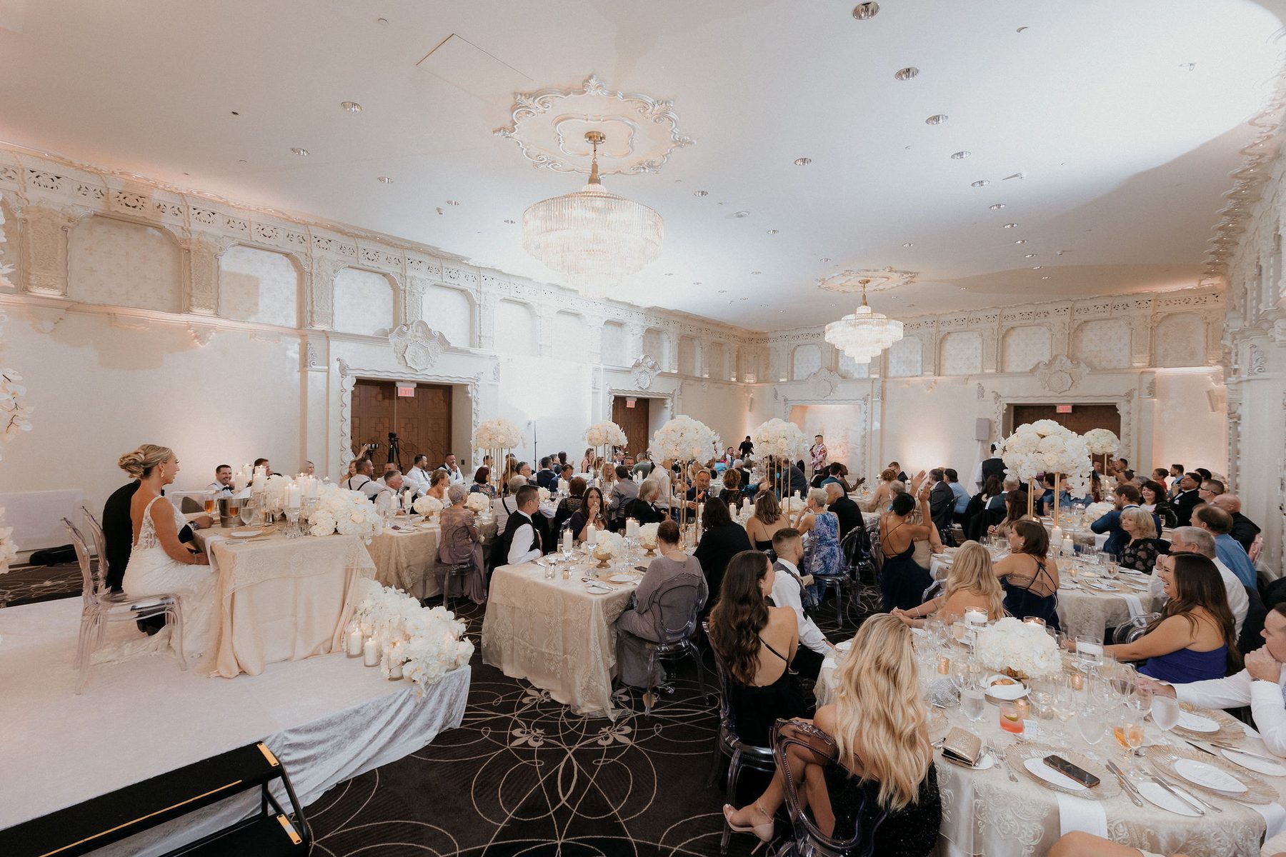 The Fairmont grand ballroom set for dinner, candlelit with tall floral centrepieces