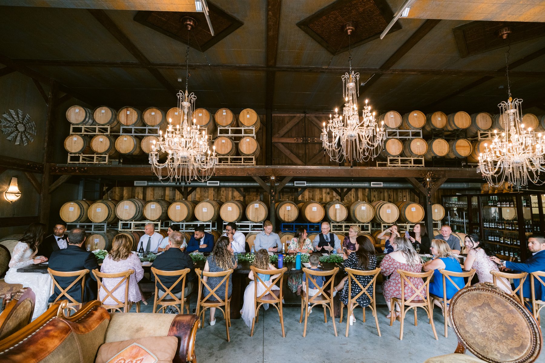 Reception in the barrel room, long tables under the chandeliers