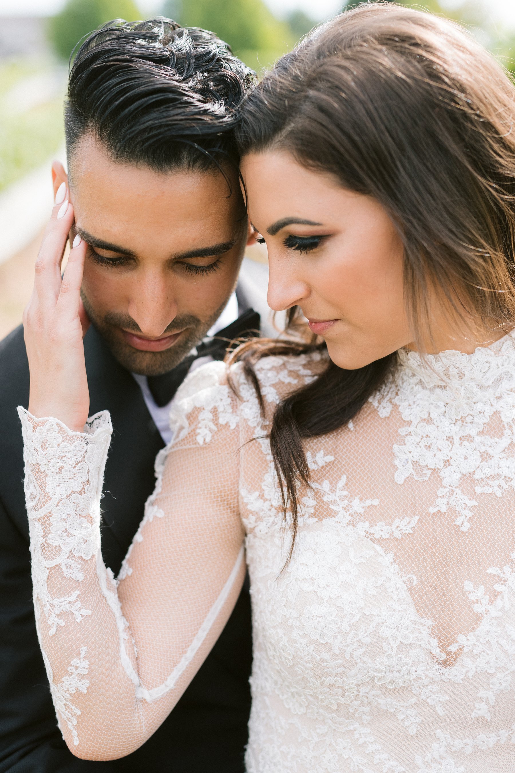 A hand on her face, lace sleeves