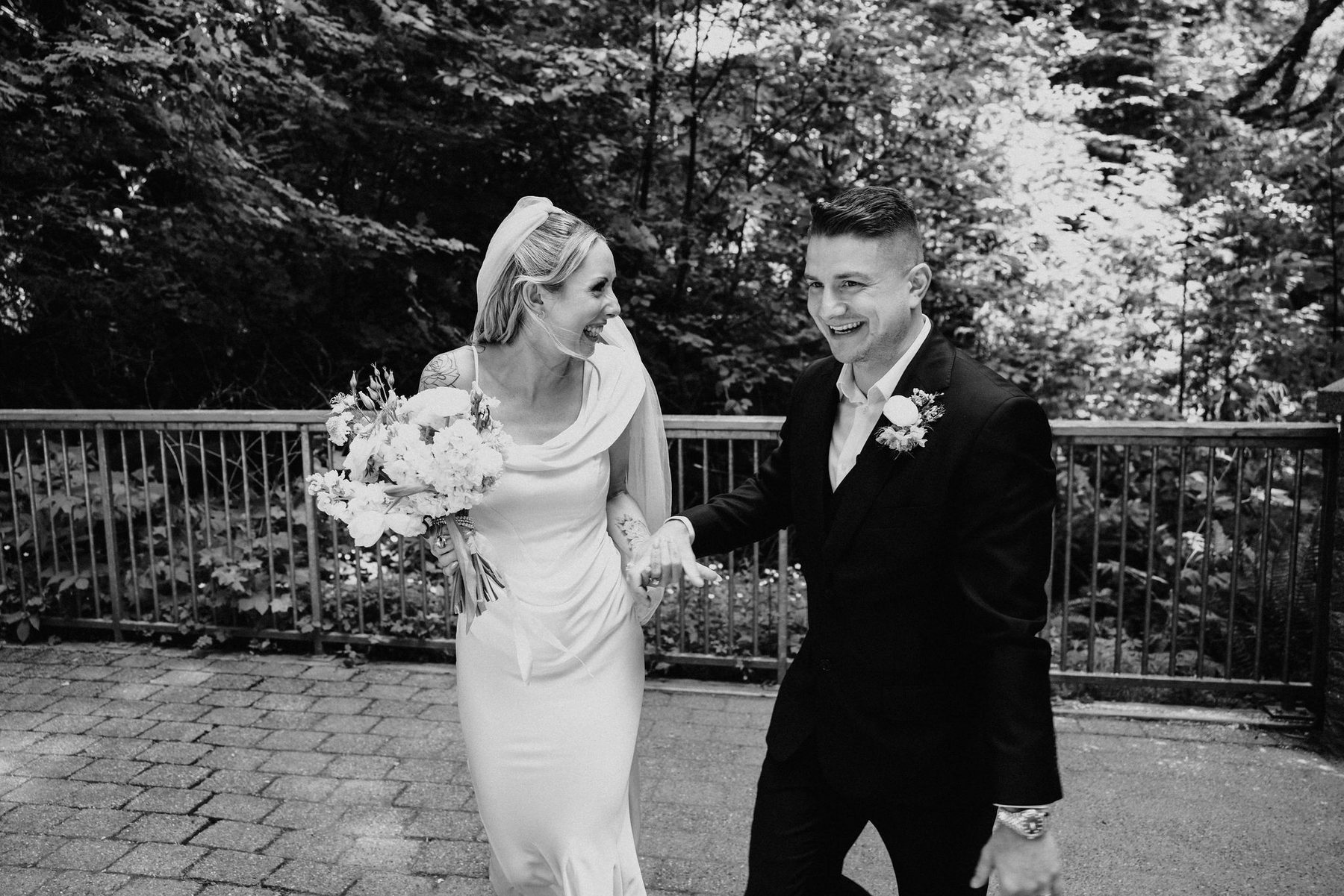Black and white photograph of the couple laughing as they walk together